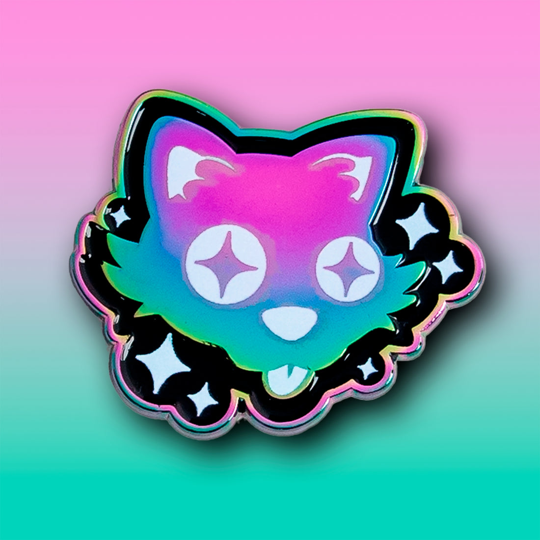 A rainbow anodised enamel pin of a silly cartoon cat, with starry eyes sticking out its tongue. It is surrounded by white sparkles on a black background.