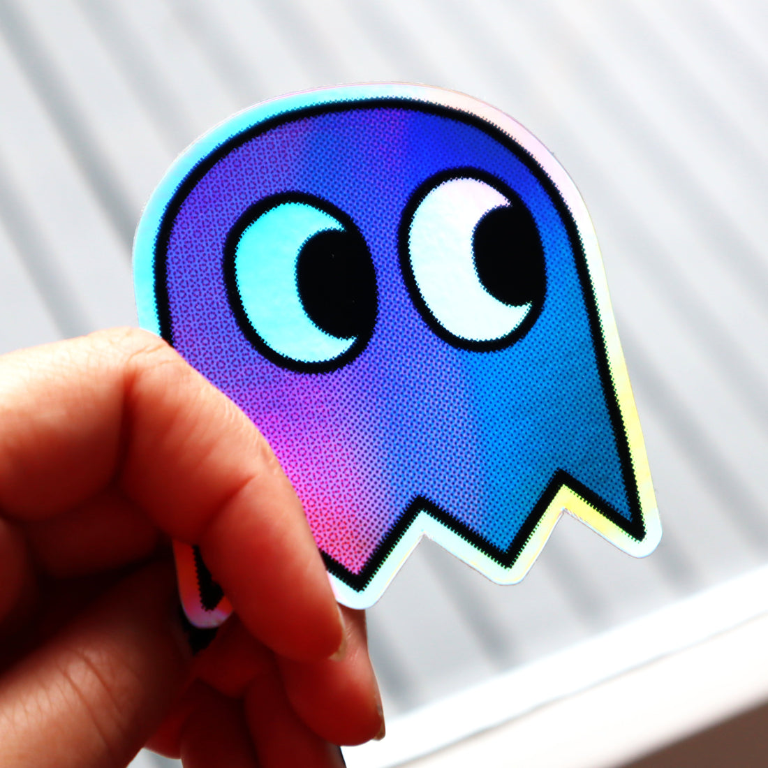 A sticker depicting a gamer-style pixel ghost in bisexual flag colours.